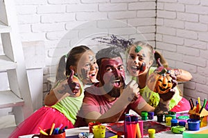 Halloween children with happy face in paint.