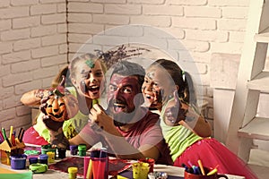 Halloween children with happy face in paint.