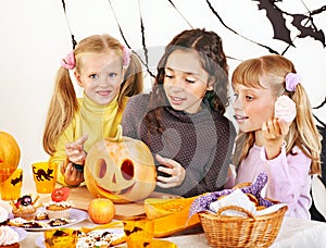 Halloween with children holding trick or treat.