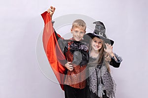 Halloween children on white background. Kids in vampire and witch costume. Happy Halloween. Banner with copy space