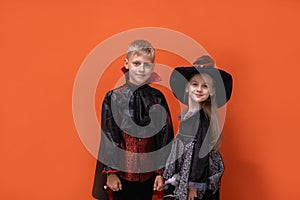 Halloween children on white background. Kids in vampire and witch costume. Happy Halloween. boy is holding smartphone