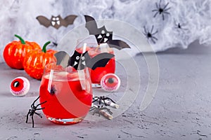 Halloween cocktail with red bubble drink and eyes made from lychee and blueberry