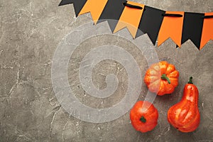 Halloween composition with pumpkins on grey background. View from above