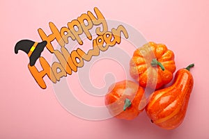 Halloween composition with pumpkins on pink background. View from above