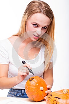 Halloween concept, happy Girl sitting at table with pumpkins pre