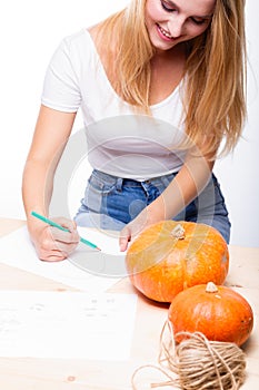 Halloween concept, happy Girl sitting at table with pumpkins pre