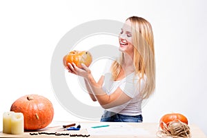 Halloween concept, happy Girl sitting at table with pumpkins pre