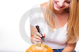 Halloween concept, happy Girl sitting at table with pumpkins pre