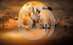 Halloween Concept Horror, night with resurrected zombie hands popping out of hell With moon floating in sky, atmosphere in cold photo