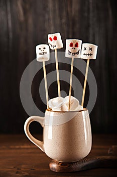 Halloween concept with marshmallow on dark background. Halloween, autumn, coffee, tea, mug, cozy. Festive concept close-up and cop