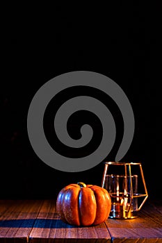 Halloween concept - Orange pumpkin lantern on a dark wooden table with black background, trick or treat, close up