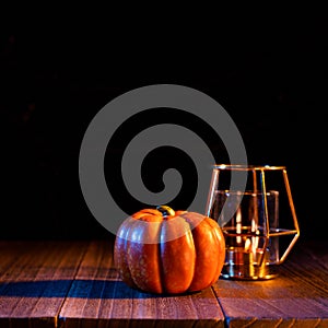 Halloween concept - Orange pumpkin lantern on a dark wooden table with black background, trick or treat, close up