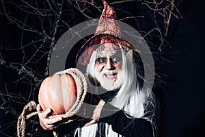 Halloween concept. Scary Halloween man in hat - studio shot close-up. Portrait of Devil with Halloween bloody make up