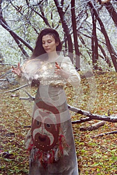 Halloween concept. the witch in the woods conjures photo