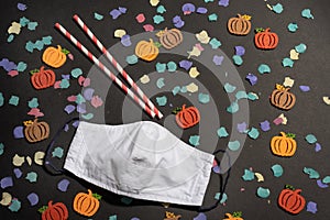 Halloween in coronavirus pandemic with felt pumpkins and confetti