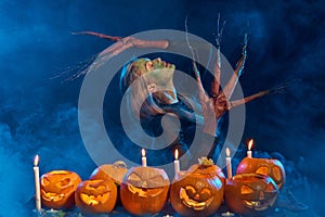 Halloween costume woman, tree girl with pumpkins