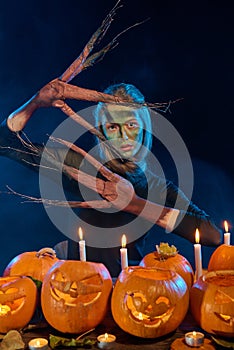 Halloween costume woman, tree girl with pumpkins