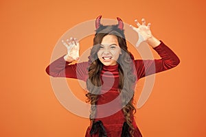 Halloween costumes designed after supernatural figures. Little devil. Little girl red horns celebrate Halloween