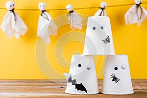 Halloween crafts paper cup ghost on wood