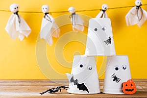 Halloween crafts paper cup ghost on wood