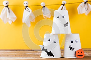 Halloween crafts paper cup ghost on wood