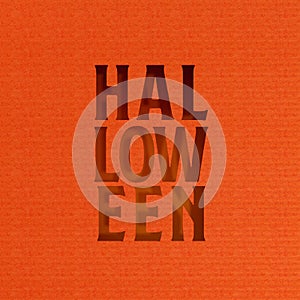 Halloween cutout paper text on vibrant red background.