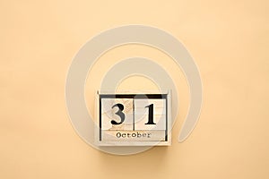 Halloween day 31 october in wooden calendar on beige background. Copy space, holiday concept