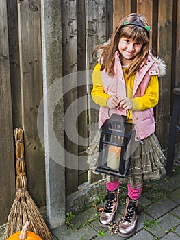 Halloween Day. Happy little girl with lantern in her hands.