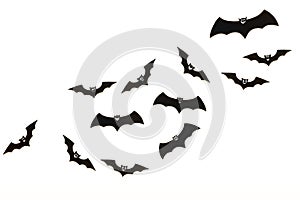 Halloween and decoration concept. Cute smiling black paper bats flying over white background.