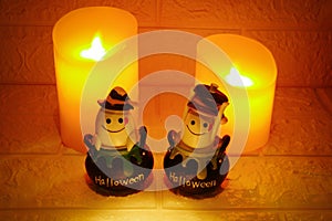 Halloween decoration ghost and candles on wall background