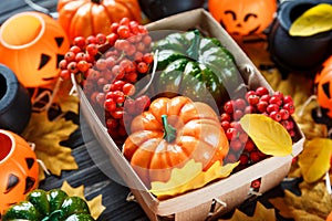 Halloween decoration with lanterns, pumpkins on the dark wooden background.