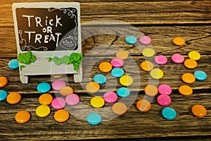 Halloween decoration trick or treat with candy on wooden background