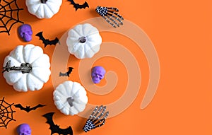 Halloween decorations bats, pumpkins and skulls on color background. Halloween concept. Flat lay, top view, copy space