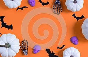 Halloween decorations bats, pumpkins and skulls on color background. Halloween concept. Flat lay, top view, copy space