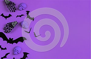 Halloween decorations bats, pumpkins and skulls on color background. Halloween concept. Flat lay, top view, copy space