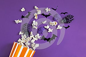 Halloween decorations bats, pumpkins and skulls on color background. Halloween concept. Flat lay, top view, copy space