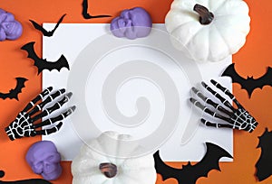 Halloween decorations bats, pumpkins and skulls on color background. Halloween concept. Flat lay, top view, copy space