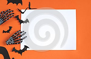 Halloween decorations bats, pumpkins and skulls on color background. Halloween concept. Flat lay, top view, copy space