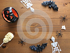 Halloween decorations and candy on wooden background