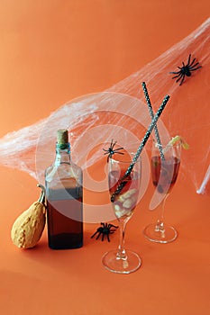Halloween drinks, wine, pumpkin, spiders and mystical decoration