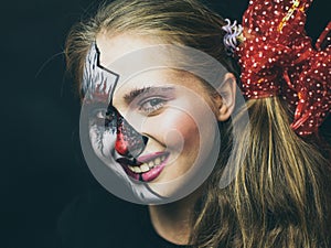 Halloween, the face of a girl is a doll, the floor of a face is dead. A woman with a horrible make-up.