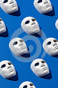 Halloween face mask pattern on blue background. Minimal holiday season concept. Flat lay
