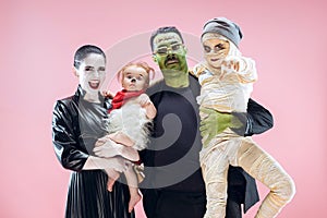 Halloween Family. Happy Father, Mother and Children Girls in Halloween Costume and Makeup photo