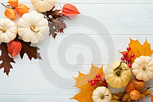 Halloween festive autumn background. Autumn decor from pumpkins, berries, maple leaves and chestnuts on old rustic white wooden