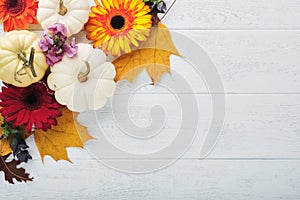 Halloween festive autumn background. Autumn decor from pumpkins, berries, maple leaves and chestnuts on old rustic white wooden