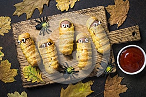 Halloween food. Scary sausage mummies in dough.