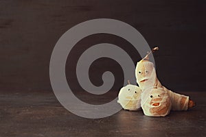 Halloween Fruit Mummy. Funny Scared orange, apple and banana wit