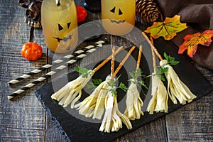 Halloween funny idea for party food. Halloween creative cheese snack on a wooden table.