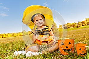 Halloween girl in costume of a bee sitting
