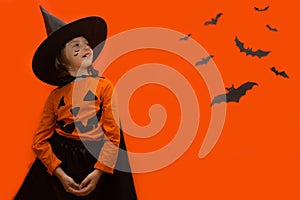 Halloween. Girl dressed as a witch with a pumpkin